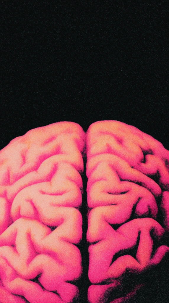 A vibrant neon pink and peach human brain emerges from the bottom edge against a pitch-black background. The anatomical folds are defined by extreme, high-contrast shadows. A heavy, noisy film grain and stippled texture coats the entire image, resembling a distressed retro screen print. The top half of the frame consists entirely of stark black negative space, emphasizing the glowing, granular texture of the isolated cerebrum below.