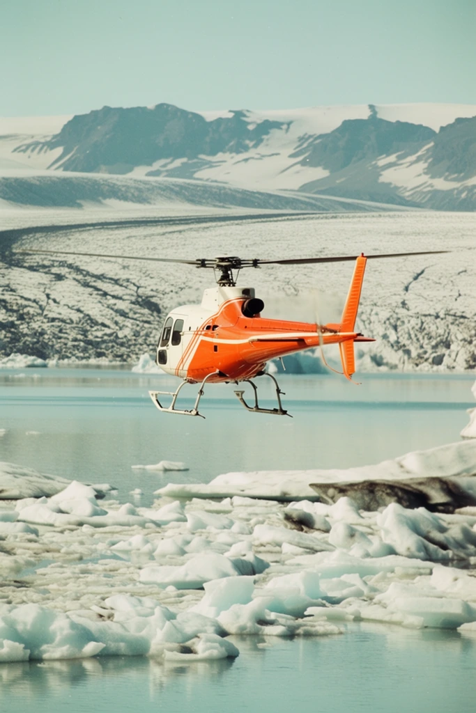A vibrant orange and white helicopter flies low over a tranquil glacial lagoon scattered with jagged icebergs. Viewed from a rear three-quarter perspective, the aircraft's main rotor blurs in motion as its landing skids hover just above the pale turquoise water. Irregularly shaped chunks of white and icy-blue floating ice dominate the foreground. Beyond the lagoon, a massive expanse of cracked, snow-covered ice fields stretches toward a distant range of rugged mountains under a clear pale blue sky. Captured in a widescreen cinematic format with a vintage film aesthetic, the composition emphasizes the stark brightness of the machinery contrasting sharply against the vast, desolate polar landscape.