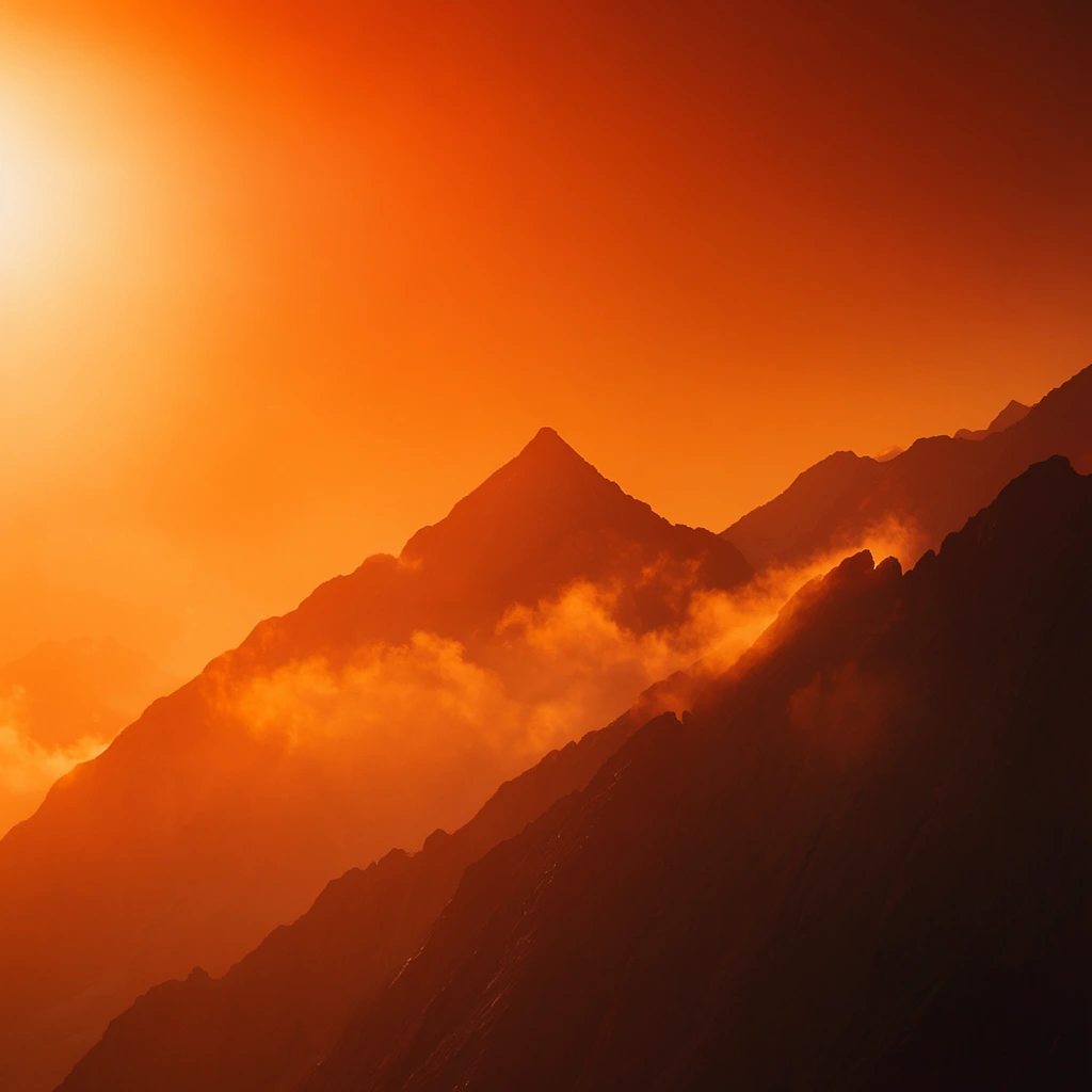 Jagged mountain peaks silhouetted against an intensely vibrant, fiery orange sky. A brilliant light source radiates from the upper left, casting a hazy, ethereal glow across the atmospheric expanse. Sharp ridges descend diagonally, featuring a prominent triangular summit piercing the glowing midground. Wispy clouds cling to the shadowed rock formations, catching the golden ambient light. The dark mountains exhibit deep amber undertones under intense backlighting. This minimalist landscape leverages a monochromatic warm palette, deep atmospheric perspective, and dramatic cinematic lighting to highlight the stark topography.