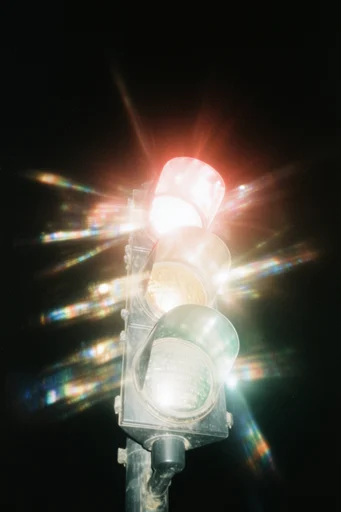 Nocturnal Prismatic Cinematic style reference image — intense starburst lens flare