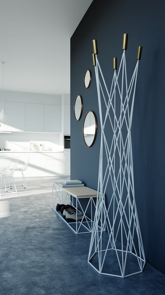 A tall, geometric white wireframe coat rack with five brass cylindrical finials stands on a mottled gray concrete floor in a minimalist entryway. The angular lattice structure is positioned in front of a dark slate-blue wall adorned with three asymmetrically arranged circular mirrors featuring thin brass frames. To the left, a low white wire shoe bench with a light wood top holds books and two pairs of shoes. In the background, strong directional sunlight floods a pristine kitchen, casting sharp, angled shadows across stark white cabinetry, countertops, and wireframe dining chairs. The photorealistic architectural rendering utilizes a cool, high-contrast color palette punctuated by warm metallic accents, sharp focus, and a wide depth of field.