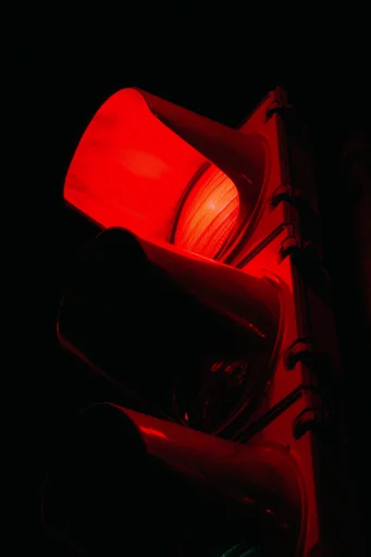 Cinematic Crimson Noir style reference image — heavy analog film grain