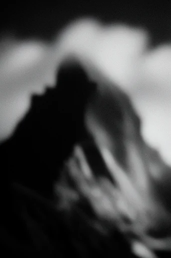 Ethereal Noir Kineticism style reference image — heavy film grain