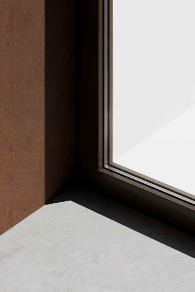 minimalist architectural detail, window corner, rusty brown textured wall, dark frame, bright white interior, light grey concrete floor, sharp geometric shadow, orthogonal lines, architectural photography