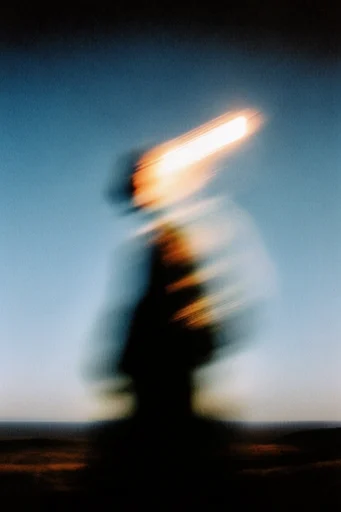 Kinetic Thermal Melancholy style reference image — heavy film grain