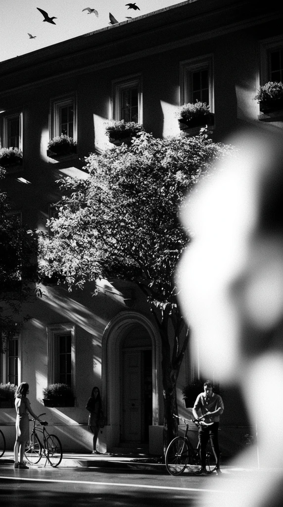 A multi-story building facade with an arched central doorway, several rectangular windows, and plant-filled window boxes, rendered in a raw, high-contrast black-and-white photography style. The composition is defined by extreme depth of field, characterized by a massive, heavily blurred, brilliantly illuminated foreground shape dominating the right side of the frame. Beyond this blown-out, abstracted foreground distortion, severe chiaroscuro lighting casts deep, crushed black shadows and stark, bright white highlights across the architecture. A large tree grows in front of the building, its canopy covering the middle section in sharp relief against the intense lighting. On the street level, a woman stands near a bicycle on the left side, another woman is partially visible near the arched doorway, and a man is positioned near a bicycle on the right side. Several birds fly above the stark roofline. The visual treatment features coarse film grain, harsh directional shafts of light, and a striking monochromatic palette.