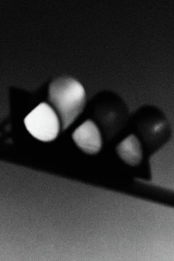 Experimental Noir Abstraction style reference image — heavy film grain
