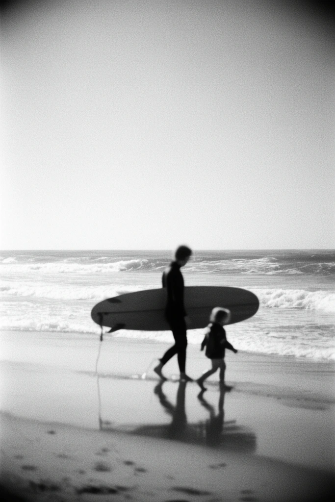 black and white photograph of an adult and small child walking along a sandy beach, adult in silhouette wearing a wetsuit and carrying a surfboard horizontally, child walking alongside, clear reflections on the wet shoreline, rolling ocean waves with white wash, expansive bright sky, minimalist composition, heavy film grain, soft blurred edges with vignette effect, high contrast vintage aesthetic