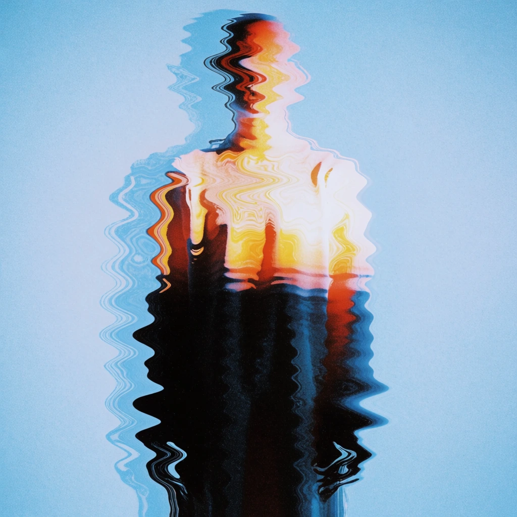 A distorted, humanoid silhouette stands vertically in the center of a grainy, light blue field, appearing as if viewed through rippling water or a digital glitch. The figure’s upper half, including the head and chest, glows with bright, warm orange and white highlights that contrast sharply against the deep black of its lower body. The entire form is heavily manipulated with horizontal, wave-like distortions that jaggedly shift the edges, creating a sense of liquid motion. To the left of the main silhouette, a faint, blue-toned echo of the figure repeats the wavy distortion pattern. The background is a solid, textured light blue that transitions into a subtle white aura immediately surrounding the central figure. The image is characterized by a heavy film grain and a high-contrast color palette of cool blue and warm orange. The composition is a centered, full-body shot from a straight-on perspective, utilizing an abstract, lo-fi artistic style to obscure specific physical features while maintaining a human-like posture.
