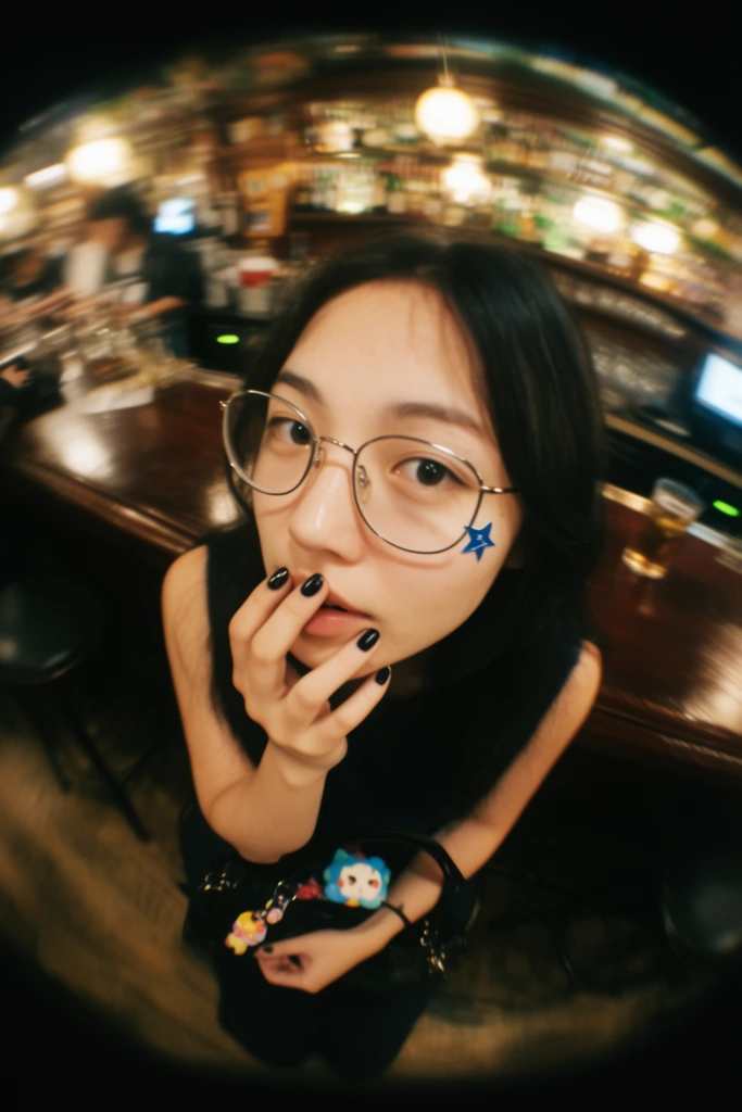 extreme fisheye lens portrait of a young woman looking up at the camera, heavy circular black vignette, thin wire-rimmed glasses, small blue star sticker on her cheek, hand resting near her mouth, dark nail polish, dark sleeveless top, holding a small colorful charm on a black bag in her lap, heavily distorted blurred bar interior, dark wooden counter, warm glowing lights, radial motion blur, candid snapshot aesthetic