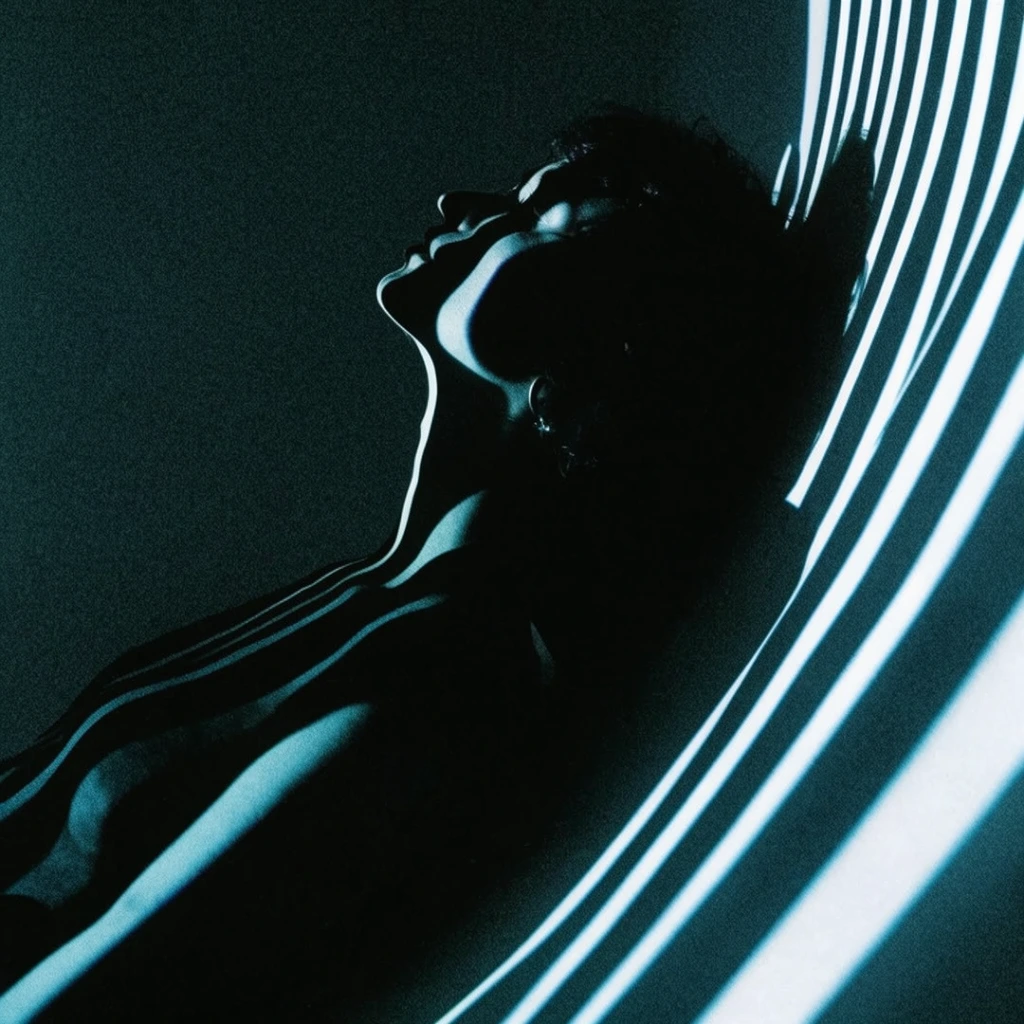 A cinematic, high-contrast portrait of a silhouetted figure leaning back, contoured by graphic, cyan-tinted bands of projected light. Thick illuminated stripes wrap across the person's face and arm against a dense, grainy dark background. Sweeping, brightly lit curved surfaces on the right balance the asymmetrical composition, creating a moody sci-fi noir chiaroscuro effect.