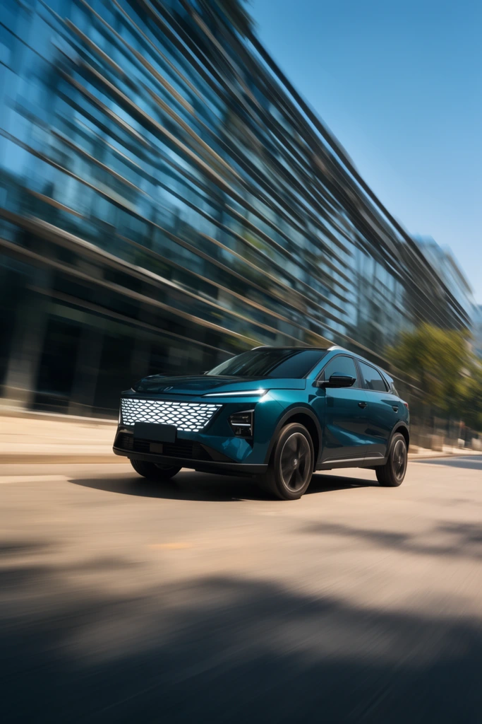 A dark teal compact SUV speeding along a sunlit street in a dynamic rolling shot with intense motion blur. The vehicle features a geometric illuminated grille and sharp body creases, passing a modern slatted glass building reflecting a clear blue sky.