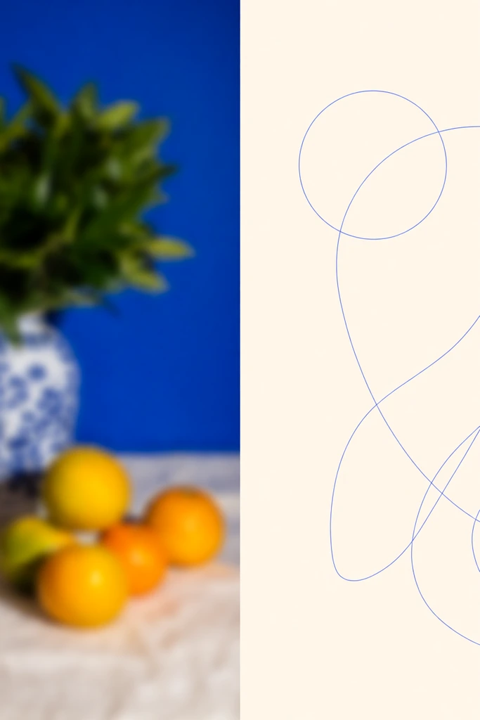 split-screen diptych, heavily blurred still life photograph on the left, green foliage in a patterned vase, yellow and orange citrus fruits, vibrant cobalt blue background, right side features a solid cream panel, delicate thin blue continuous line art, abstract flowing organic shapes intersecting a perfect circle, stark contrast between soft photographic blur and crisp minimal illustration