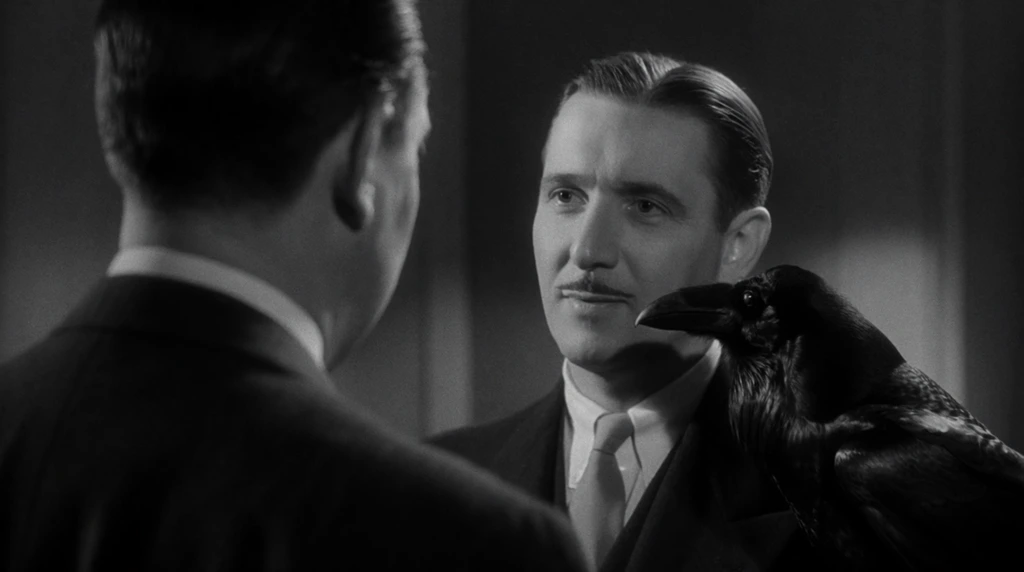 vintage black and white film still, film noir style, over-the-shoulder shot of two men conversing, man facing camera with slicked-back hair and thin pencil mustache, wearing a dark suit and light tie, large black raven perched near his left shoulder, foreground man seen from behind in dark suit, shadowy room, soft dramatic chiaroscuro lighting, cinematic composition, grainy film texture