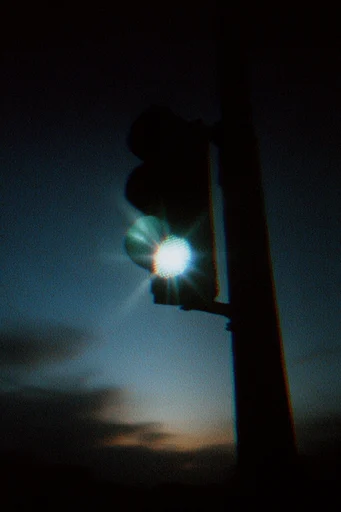 Cinematic Nocturnal Grain style reference image — anamorphic lens flare