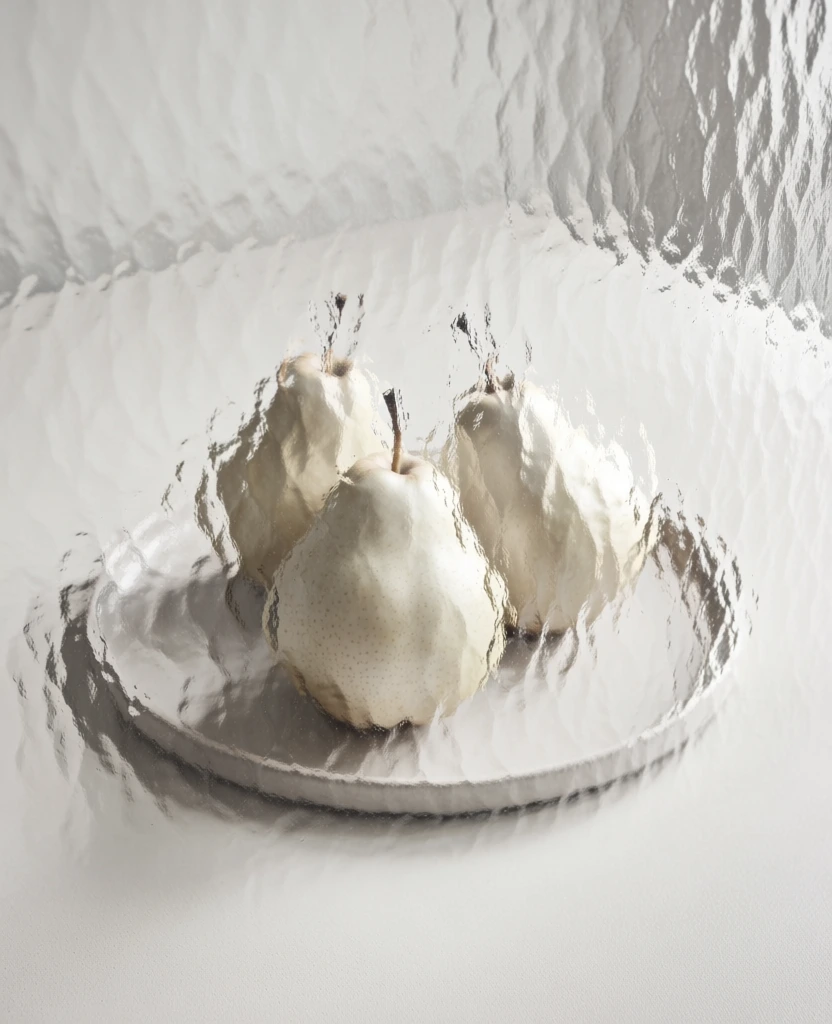 minimalist still life, three pears resting on a flat round ceramic plate, viewed through a sheet of heavily textured hammered glass, creating distorted organic patterns, soft diffused high-key lighting, ethereal and airy aesthetic, monochromatic off-white and pale cream color palette, centered vertical composition, clean background, fine art photography style, subtle shadows, neutral tones, muted fruit colors softened by the rippled glass texture