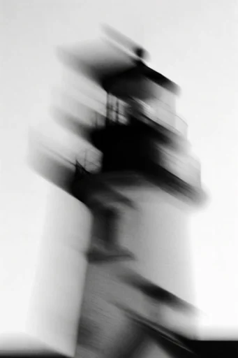 Kinetic Ghostly Monochrome style reference image — minimalist studio background