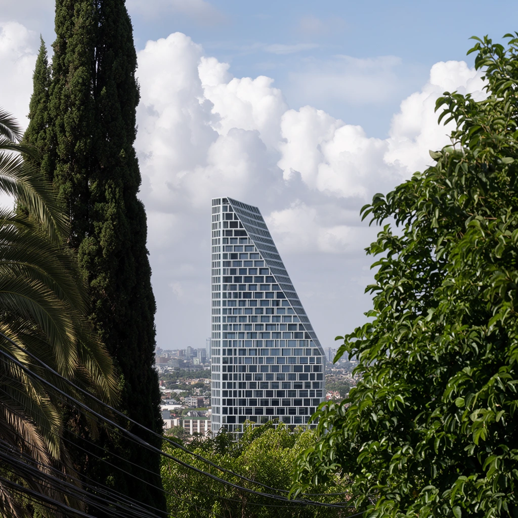 modern asymmetrical skyscraper with a white geometric grid facade and dramatic sloping profile, rising above a distant cityscape, framed by lush foreground greenery, palm fronds and a tall dark cypress tree on the left, thick leafy branches on the right, black power lines crossing the lower left, bright sky with large puffy cumulus clouds, natural daylight, architectural landscape photography, telephoto compression