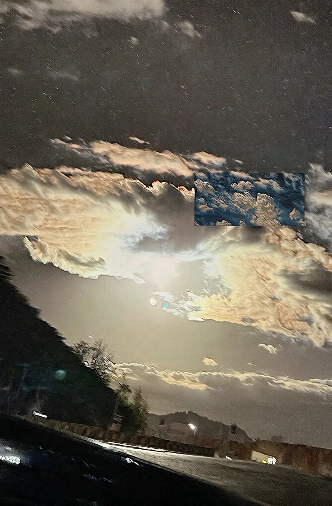 hazy landscape at night, sloping landmass on the left in deep silhouette, central celestial light source bursting through heavy clouds with high-contrast glare, captured with high iso digital noise and grain, warm sodium-vapor amber light against charcoal skies, soft-focus atmospheric haze, gritty smartphone photography style, low-light urban nocturne aesthetic, diffused lens flare, slight motion blur, desaturated tones, raw casual framing, high-signal low-fidelity texture.