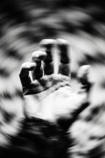 Monochrome Kinetic Vertigo style reference image — radial vortex distortion