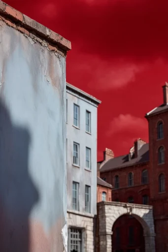 Saturated Surreal Minimalism style reference image — vibrant crimson red background