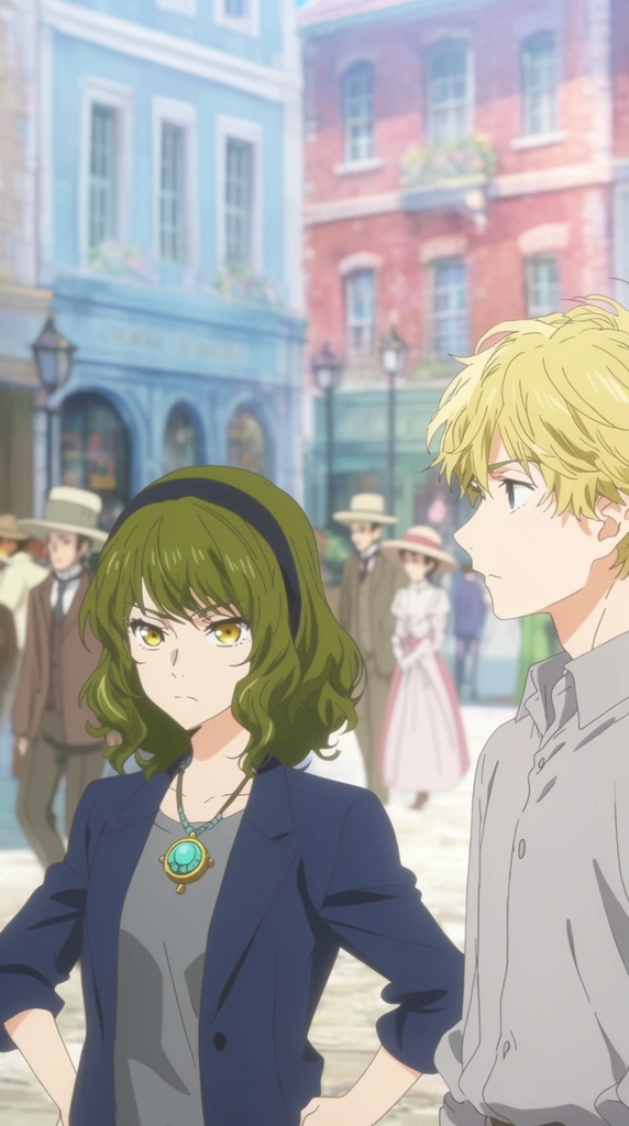 Two anime-style characters stand in a brightly lit European-style plaza. In the left foreground, a young woman with wavy olive-green hair, a dark headband, and striking golden-yellow eyes stands with her hands on her hips, displaying a serious expression. She wears a dark blue blazer over a grey top and a prominent turquoise and gold circular pendant necklace. To her right, a young man with messy blonde hair and a light grey button-down shirt is captured in profile, looking left. The vibrant daytime street scene behind them features softly blurred pastel blue and red brick buildings, arched storefronts, and vintage street lamps. Pedestrians in period attire, including suits and long dresses with wide-brimmed hats, stroll through the sunlit square. The cinematic 2D animation style employs a soft, bright color palette with a shallow depth of field.