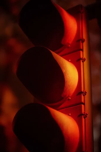 Graphic Chiaroscuro Noir style reference image — saturated gelled lighting
