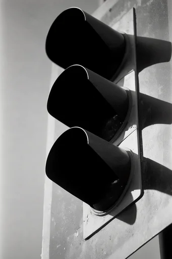 Stark Noir Minimalism style reference image — stark chiaroscuro lighting