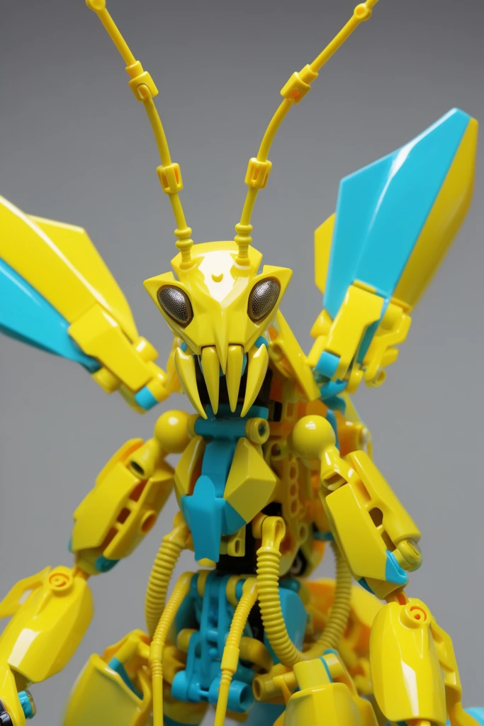 A glossy, interlocking plastic construction toy of a vibrant yellow and cyan cybernetic mantis stands against a neutral gray background. The figure features a sharp triangular head with textured compound optical sensors and jagged vertical mandibles. Its intricate body incorporates ribbed mechanical hoses, ball joints, and smooth armored plating. Large, swept-back geometric thruster vanes and slender articulated antennae extend upward from its thorax, emphasizing the highly engineered, modular design of the shiny plastic components.