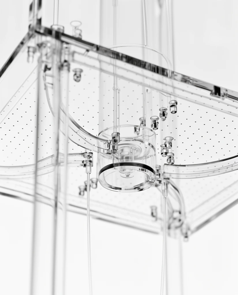 transparent scientific apparatus, low angle close-up, clear acrylic panels, delicate glass tubes, flat perforated plane with dot grid, curved transparent brackets, small mounting nodes, suspended cylindrical hub, black and white, high key lighting, shallow depth of field, clean white background