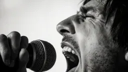 A rock singer screams into the microphone, slow motion, black and white, close-up, hyper-detailed, macro photography, pores, facial hair, vibration, sweat, noise. Desaturated, sharp focus.